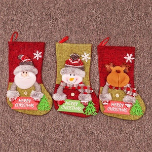 Close-up of Santa, Snowman and Reindeer 3D dolls on Christmas stocking gift bags