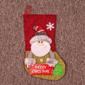 Detail of Christmas stocking featuring 3D Santa Claus and Merry Christmas wooden plaque