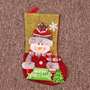Detail of burlap Christmas stocking featuring 3D snowman and Merry Christmas sign