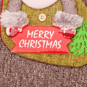 Detailed macro view of burlap Christmas stocking with grey faux fur trim and wooden button