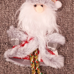 Detail of plush Santa ornament with red plaid fabric and long white beard for Xmas
