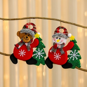 Hanging Christmas plush ornaments featuring Santa and snowman on a wooden branch