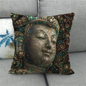 Close-up of mosaic Buddha face linen pillow cover on a grey fabric sofa