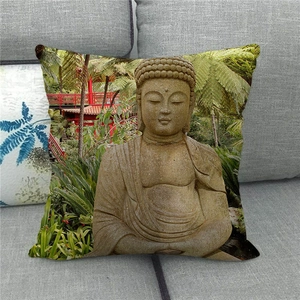 Linen pillow cover with Buddhist statue print on a gray sofa for home decor