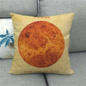 Close-up of linen pillow cover featuring a Venus planet design on a grey sofa