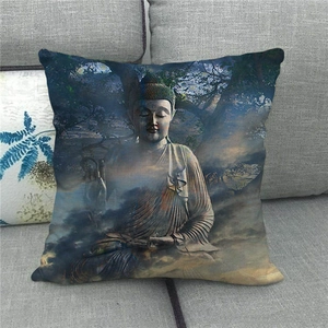 Close-up of a linen cushion cover with a golden Buddha meditating under a tree