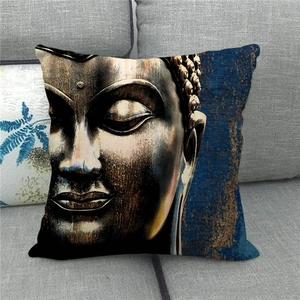 Macro detail of linen pillowcase featuring Buddha art print on a gray fabric sofa