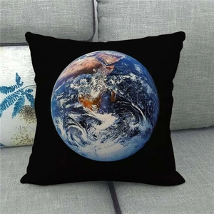 Detailed close-up of Earth printed linen pillowcase on a grey fabric sofa