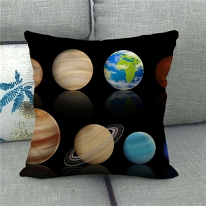 Detail of linen pillowcase with solar system planets reflection on a grey sofa