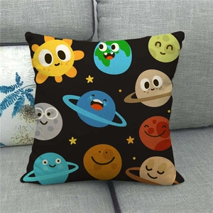 Detail of linen pillowcase with cartoon solar system planets on a gray sofa
