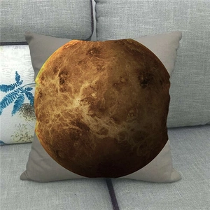Macro detail of linen pillowcase with cosmic planet print on a grey fabric background