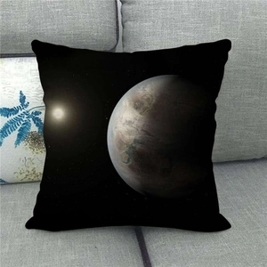 Detailed view of cosmic space print pillowcase on a gray sofa with star and planet motif