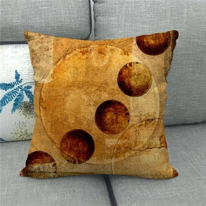 Vintage galaxy planet linen cushion cover with abstract geometric patterns on a grey sofa