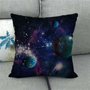 Detailed view of linen cushion cover with galaxy and planet patterns on a grey sofa