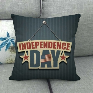 Close-up of Independence Day linen pillowcase with blue stripes on a grey fabric sofa