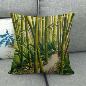 Linen pillow cover featuring green bamboo forest ink painting on a grey sofa background