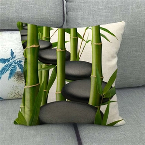 Detailed texture of linen cushion cover featuring green bamboo and Zen stones on a sofa