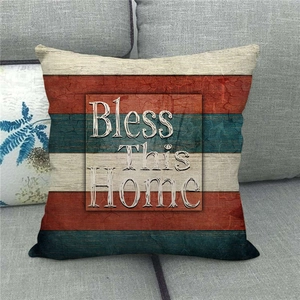 Detailed texture of rustic linen pillowcase with Bless This Home text on a gray sofa