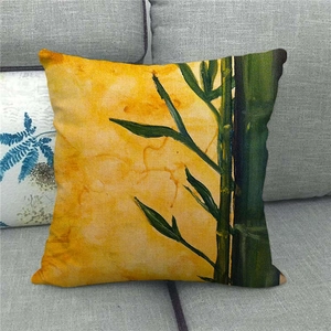 Close-up of linen pillowcase with green bamboo ink painting on yellow texture background