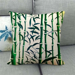 Close-up of bamboo ink painting linen pillow cover displayed on a grey sofa