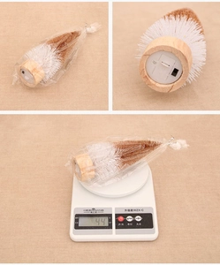 Detailed view of mini light-up Christmas tree with wooden base and weight measurement