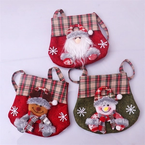 Detailed view of three felt Christmas gift bags with 3D Santa, Reindeer and Snowman plush decor