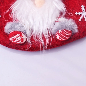 Detail of Christmas gnome gift bag with red felt base and white faux fur beard decor