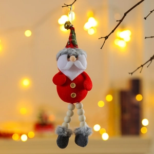 Detail of Santa Claus ornament with plaid hat and golden bell hanging on a wooden branch