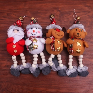 Detail of Christmas plush ornaments with wooden beads, bells and checkered scarves