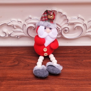 Detail view of Santa Claus ornament with wooden beads, red felt and a golden bell