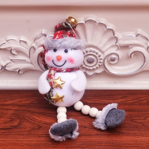 Detail of Christmas snowman ornament with red green plaid scarf and golden bell charm
