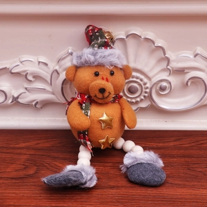 Detail of Christmas teddy bear ornament with red plaid hat and golden bells