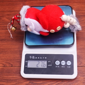 Detailed view of 27.6g weight measurement for red Christmas plush doll hanging ornament