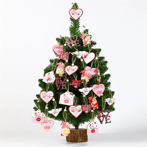 12-piece Valentine's wooden ornaments set with pink gnomes and hearts on a green tree