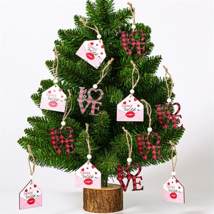 Detail of wooden Valentine heart pendants on a tree with LOVE letters and envelopes