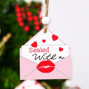 Macro shot of wooden envelope charm with red hearts and sealed with a kiss text