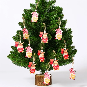 Detail of wooden Valentine Gnomes hanging on a mini tree with 'Kisses' and 'Be Mine' text