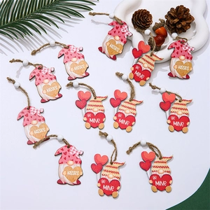 Detail of Valentines Day wooden gnome ornaments with Kisses and Be Mine text