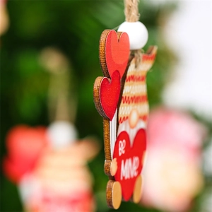 Detail of wooden Valentine gnome ornament with red heart and BE MINE text inscription