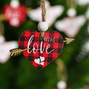 Macro shot of heart-shaped buffalo plaid wooden tag with hello love text and arrow