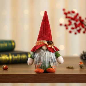 Close-up of a handmade Christmas gnome doll with a red knit hat and pine cone details