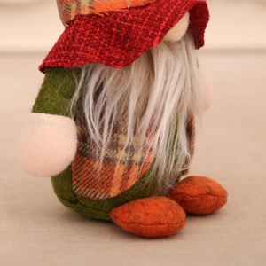 Detail of harvest gnome figurine featuring red burlap hat and long white plush beard