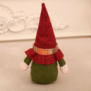 Detail of a Christmas gnome doll with a red plaid hat and green felt body decor