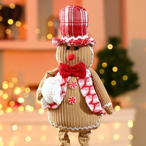 Detail of corduroy Christmas gingerbread man toy with red plaid hat and bow tie
