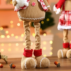 Detail of gingerbread man plush with red checkered scarf and candy cane buttons