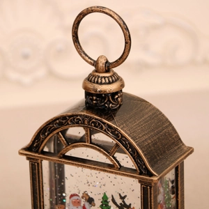 Close-up of vintage bronze Christmas snow globe lamp with Santa Claus and glitter
