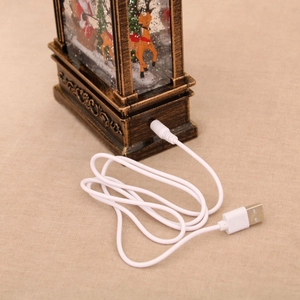 Detail of vintage Christmas snow globe lamp featuring USB power port and cable