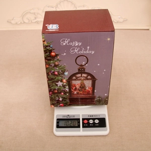 Detailed close-up of the purple Christmas music box gift set weighing 1020g on a scale