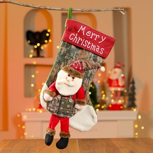 Large Christmas stocking with 3D Santa doll on green fabric, hung on tree branch decoration
