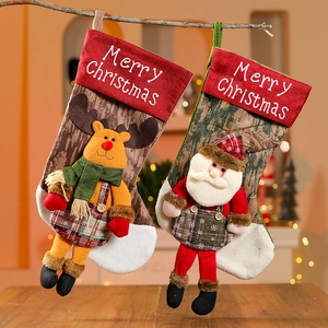 Close-up of Santa and reindeer Christmas stockings with Merry Christmas embroidery